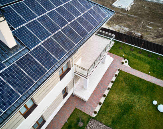 Modern residential house with solar panel system on roof.