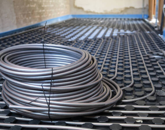 Underfloor heating system pipes on insulation. Radiant floor.