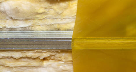 Mounted green plasterboards to an aluminum loft frame, visible yellow vapor barrier foil.
